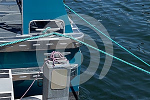 Green roap tied down to dock area near a saltwater marina