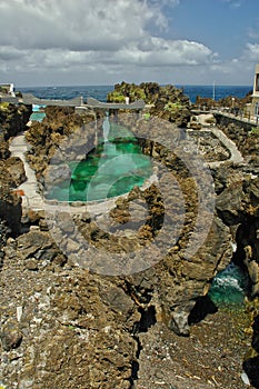 Green rock pools by the ocean