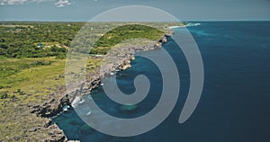 Green rocky shore of ocean gulf aerial view. Cliff sea coast with serene seascape. Amazing landscape