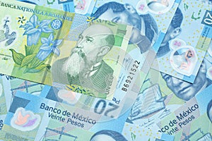 A green Romanian leu bill with Mexican twenty peso bank notes