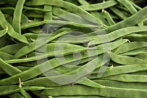 Green romano beans on the counter in the market