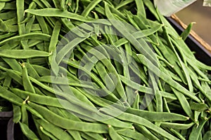 Green romano beans on the counter in the market