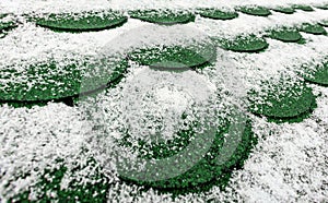 Green roofing in winter, snow falling on shingles