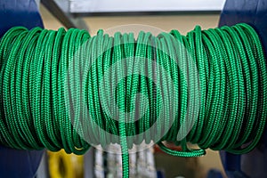 The green rope is reeled up on the coil in shop. A saving or safety rope for climbers