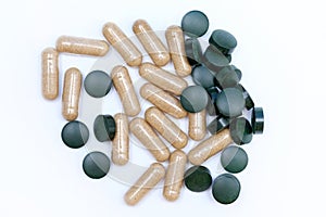 Green round pills and capsules top view.