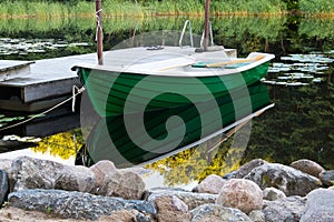 Green rowboat near dommy