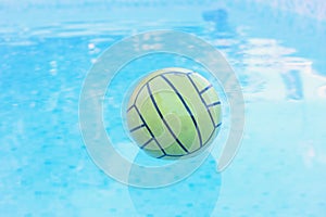 green rubber ball floating in a pool