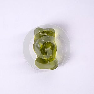 Green rubber bear candy on a white background