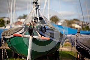 Green Sailing Dinghy Boat on Trailer in Boat Yard