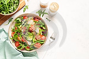 Green salad with baked chicken breast, fresh salad leaves and vegetables.