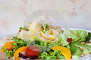 Green salad with cheese and fruits on plate