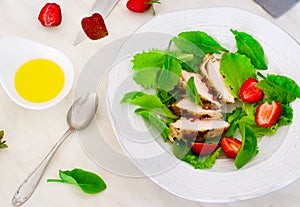 Green salad with chicken and strawberry