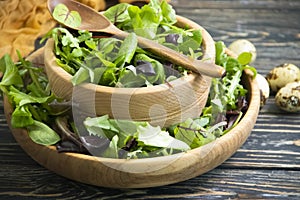Green salad leaves cooking on wooden backgroundn green, organic