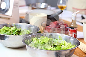 Green salad leaves are on a kitchen