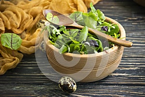 Green salad leaves on wooden backgroundn green, organic photo