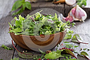 Green salad leaves in a wooden bowl