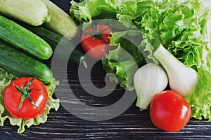 Green salad, tomatoes, cucumbers, zucchini, squash, and onion