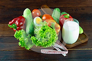 A green salad in wood cup consisting of a mixture With milk in a glass