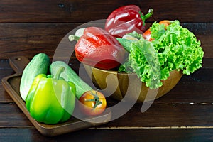 A green salad in wood cup consisting of a mixture of small usually Green leafy vegetable, Various kinds of vegetables