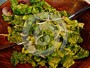 Green Salad in a Wooden Bowl with Utensils