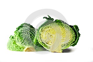 Green savoy cabbage, a healthy winter vegetable, halved head isolated on a white background