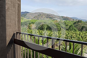 Green scenery view from suite balcony of a resort hotel.