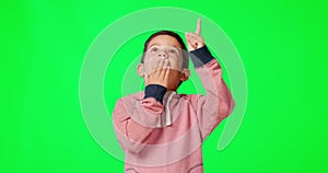 Green screen, child and boy with surprise, pointing up and happiness against a studio background. Male kid, young person