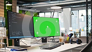 Green screen computer display in modern startup office displaying code snippets