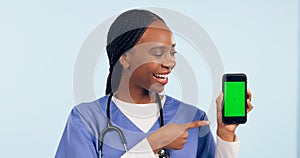 Green screen, doctor and woman with phone pointing for telehealth, wellness app and medical news. Healthcare, mockup and