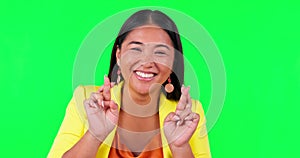 Green screen, fingers crossed and happy woman face in studio with good luck, sign and wish on mockup background. Smile