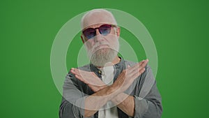 Green Screen.An Old Man Shows a Prohibition and Stop Sign.