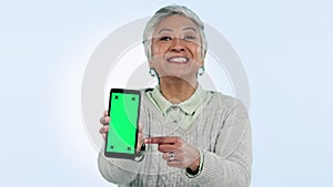 Green screen, phone and senior woman hands show presentation and pointing to app tracking markers on blue background