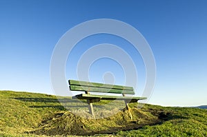 Green seat on hill