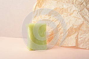 A green set of handmade soap on beige wrinkle paper background.