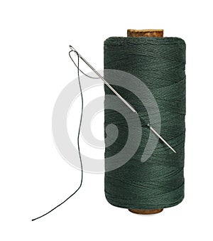 Green sewing thread with needle on white background