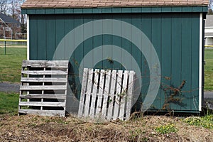 The green shed stores different machinery for the baseball fields.