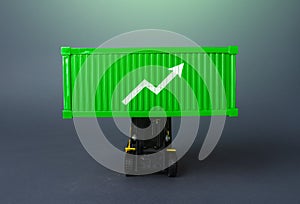 Green shipping container with up arrow. Increase in imports and exports of goods. Trade traffic increasing. Production rise. photo