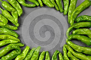 Green Shishito peppers in a circle with an empty space in the center
