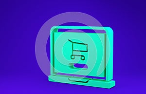 Green Shopping cart on screen laptop icon isolated on blue background. Concept e-commerce, e-business, online business