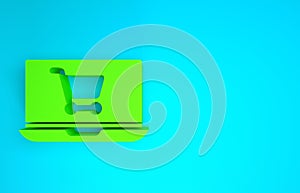 Green Shopping cart on screen laptop icon isolated on blue background. Concept e-commerce, e-business, online business