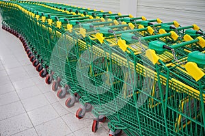 Green shopping carts in a row