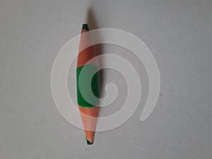 Green short pencil that is sharpened on both sides, bullet shaped