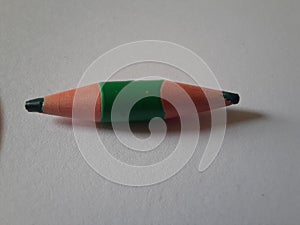 Green short pencil that is sharpened on both sides, bullet shaped