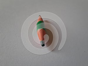 Green short pencil that is sharpened on both sides, bullet shaped