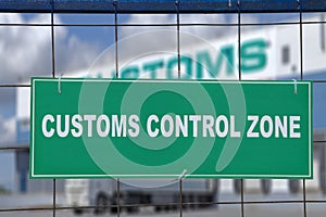 Green sign, customs control zone, on fence of logistic terminal.