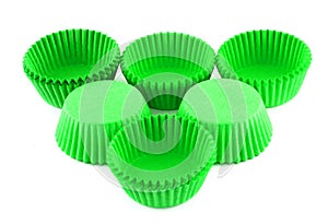 Green silicone form for cooking muffin and cupcake on white background. Molds for sweet and delicious muffins