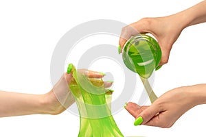 Green slime toy in woman hand with green nails  on a white background