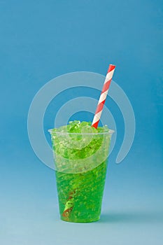 Green slushie and blue background