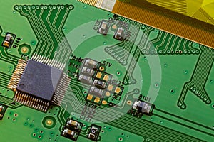 Green small electronic PCB circuit close-up background