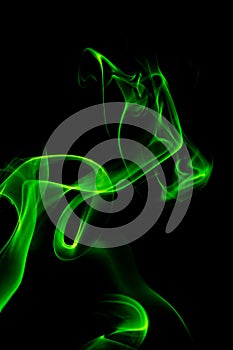 Green smoke on a black background, abstract smoke swirls